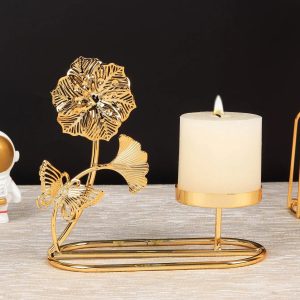 Support doré pour bougie en métal avec design floral